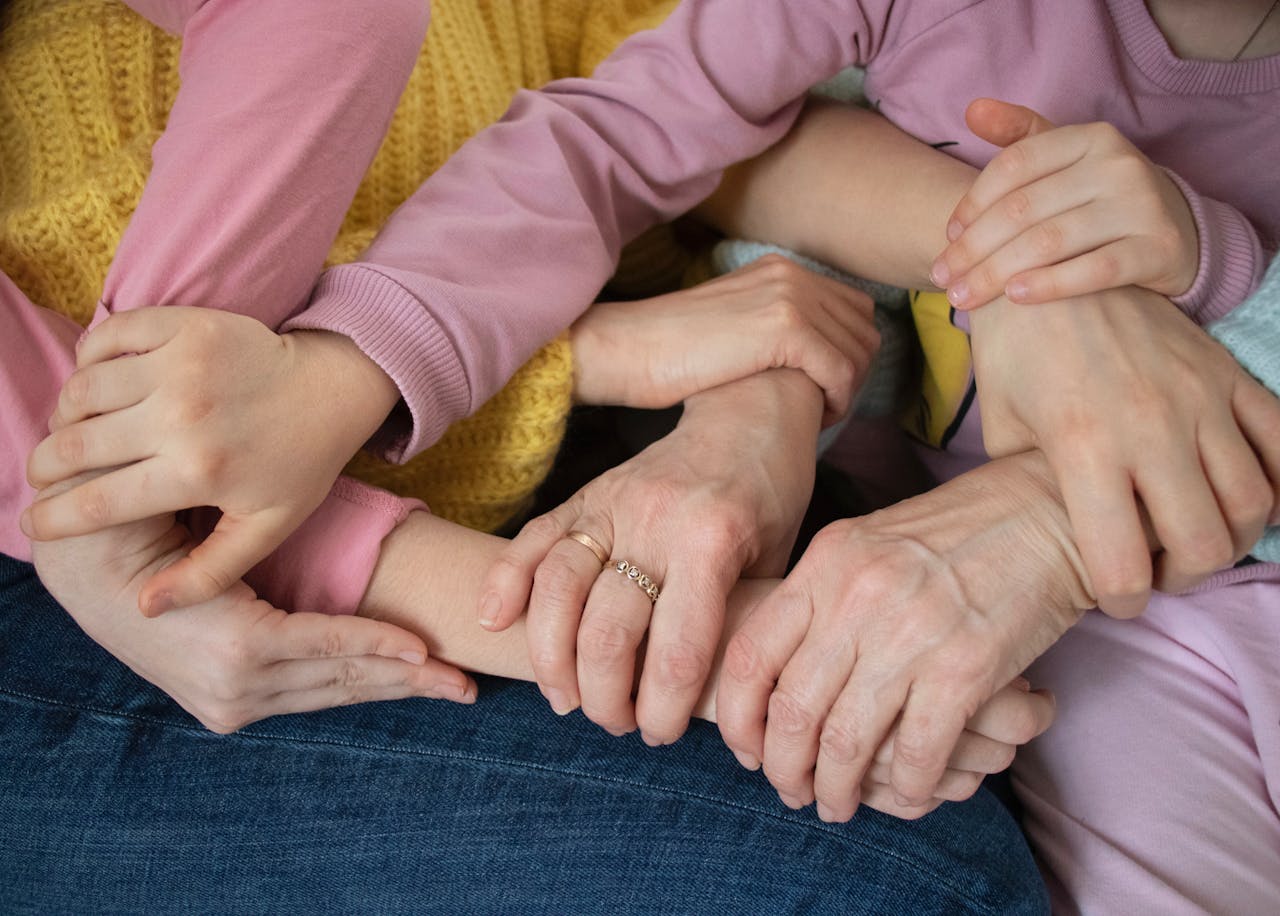 about-us Multiple arms intertwined, symbolizing family unity and support across generations.