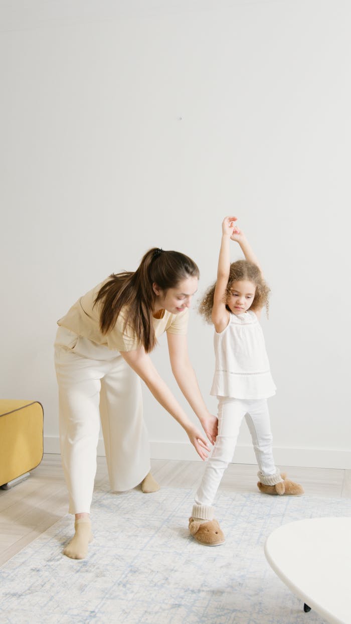 A mother and daughter enjoying a fun exercise session at home, promoting a healthy lifestyle.